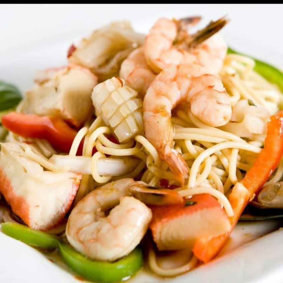 Thai Corner Food Express's seafood noodle dish with shrimp, squid, crab, and vegetables.