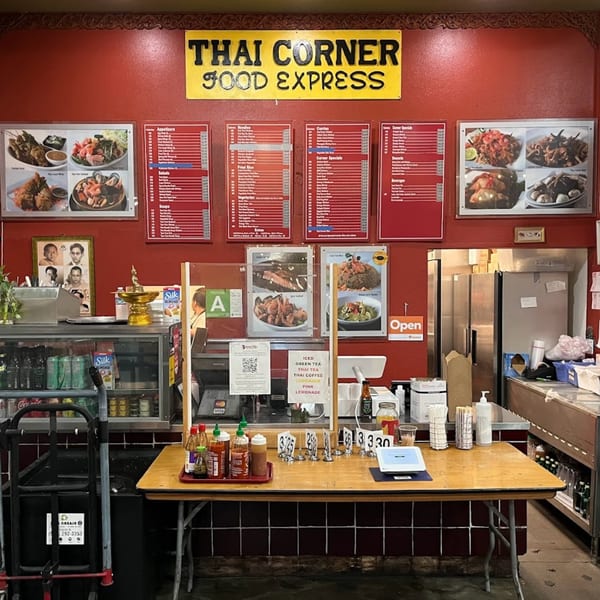 The interior of Thai Corner Food Express, showing the counter, menus, and food display.